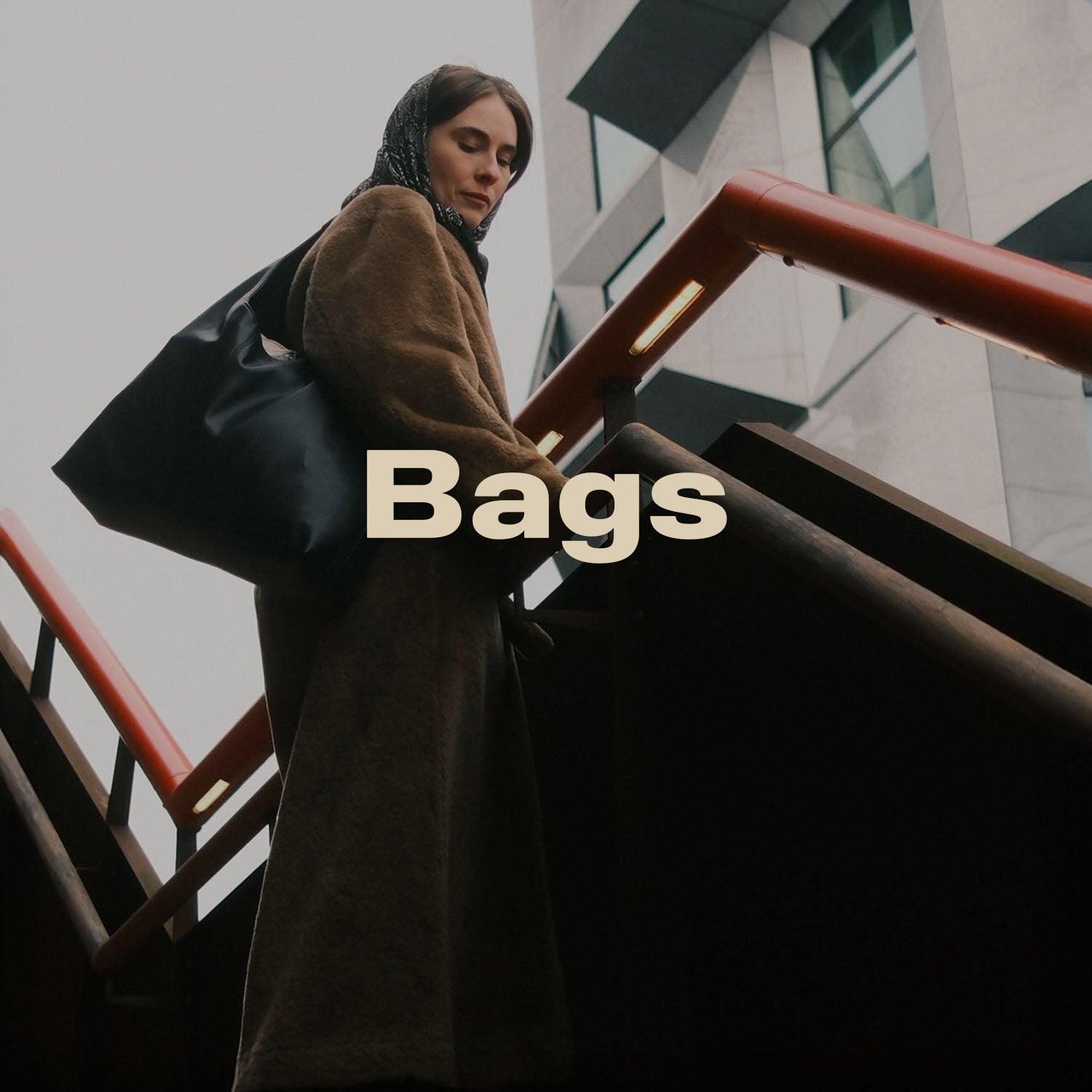 Person holding a black bag with 'Bags' text overlay