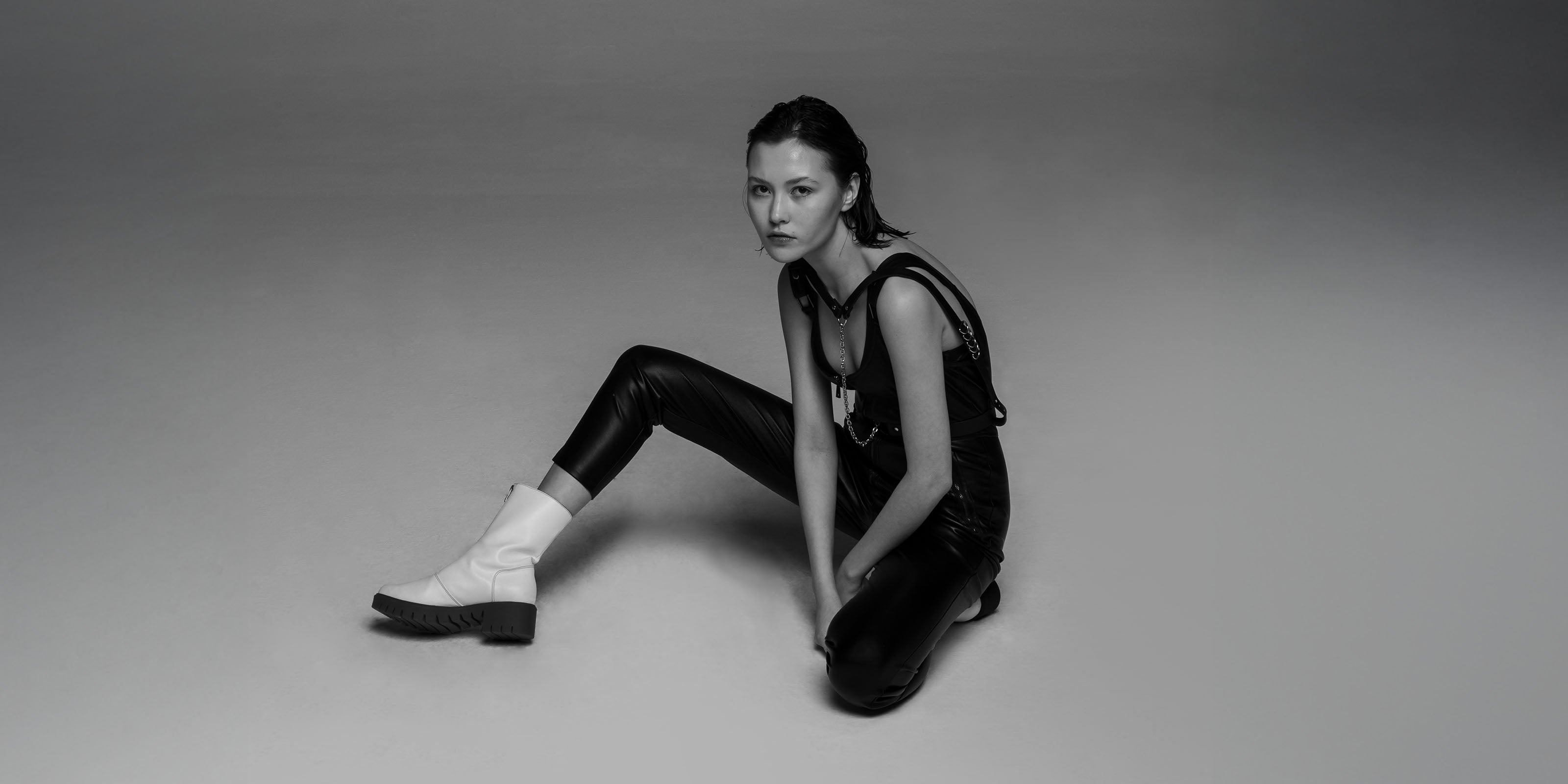 girl with white boots sitting on the floor 